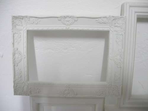 A stunning white plastic wall mounted photo frame for 8 photos. Lifespace Sale