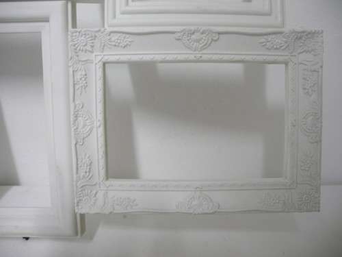 A stunning white plastic wall mounted photo frame for 8 photos. Lifespace Sale