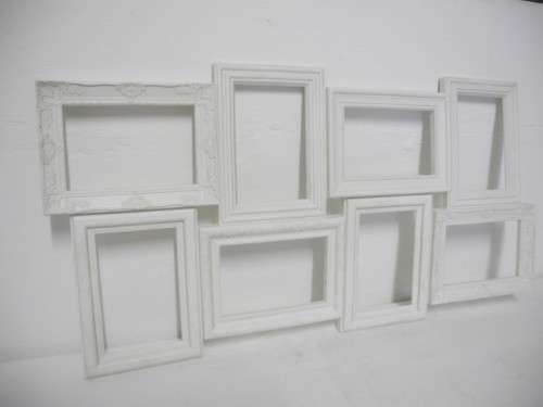 A stunning white plastic wall mounted photo frame for 8 photos. Lifespace Sale