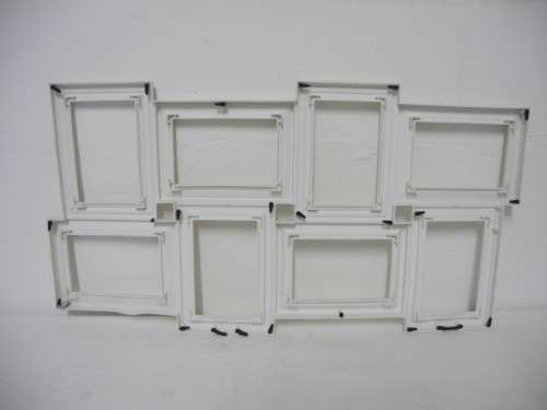 A stunning white plastic wall mounted photo frame for 8 photos. Lifespace Sale