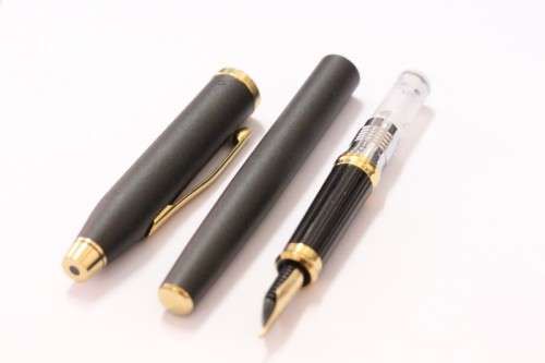 A stunning vintage black with gold trim Cross fountain pen.