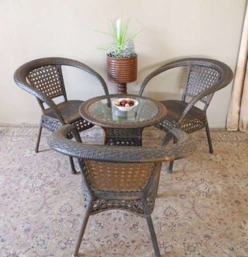 A fabulous four piece woven plastic outdoor patio set, three chairs and table.