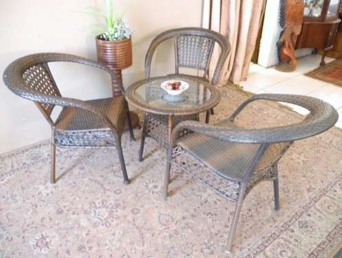 A fabulous four piece woven plastic outdoor patio set, three chairs and table.