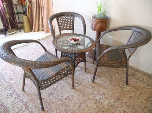 A fabulous four piece woven plastic outdoor patio set, three chairs and table.