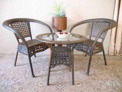 A fabulous four piece woven plastic outdoor patio set, three chairs and table.