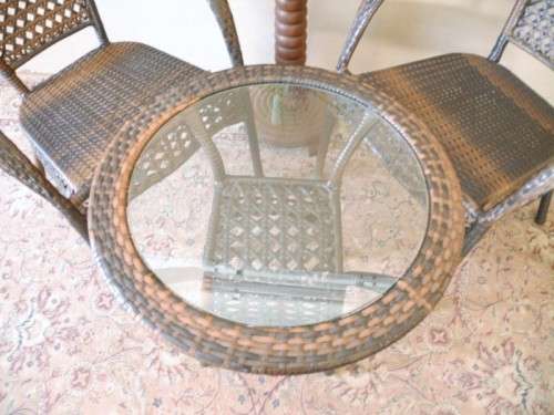 A fabulous four piece woven plastic outdoor patio set, three chairs and table.