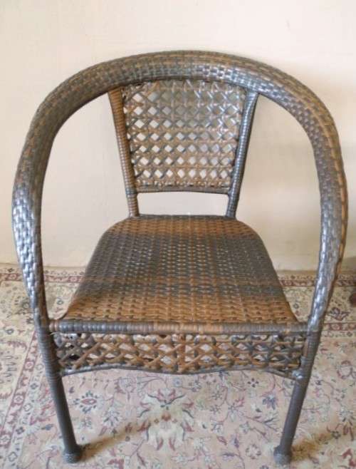 A fabulous four piece woven plastic outdoor patio set, three chairs and table.