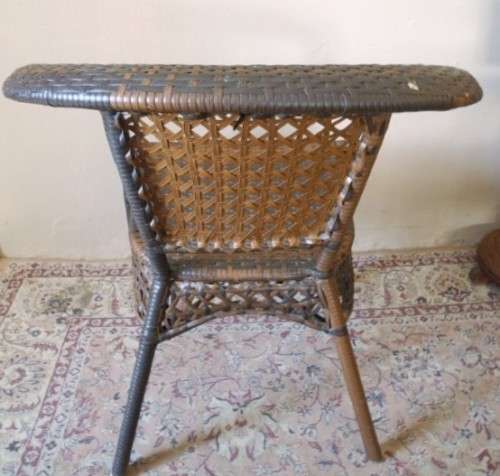 A fabulous four piece woven plastic outdoor patio set, three chairs and table.