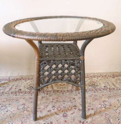 A fabulous four piece woven plastic outdoor patio set, three chairs and table.