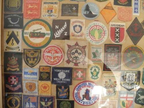 An extra large framed behind glass assortment of Scout badges-Lifespace Sale