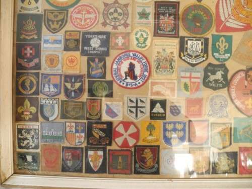An extra large framed behind glass assortment of Scout badges-Lifespace Sale