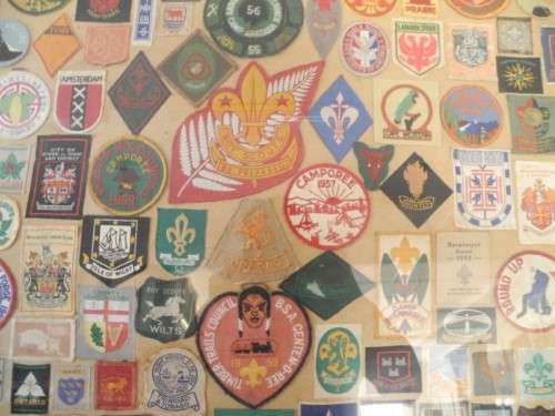 An extra large framed behind glass assortment of Scout badges-Lifespace Sale