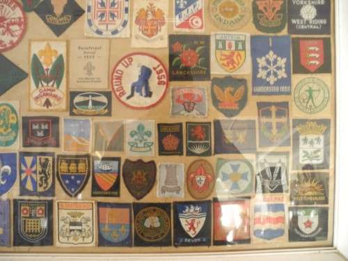 An extra large framed behind glass assortment of Scout badges-Lifespace Sale