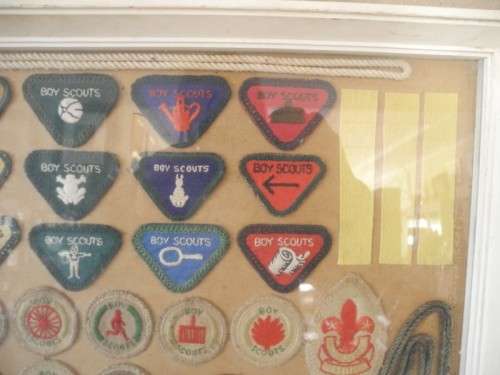 A framed behind glass assortment of Scout badges-Lifespace Sale