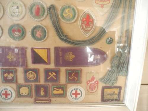 A framed behind glass assortment of Scout badges-Lifespace Sale