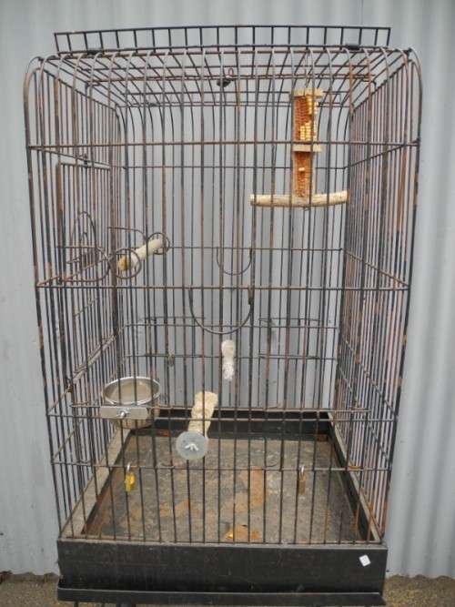 A well made metal bird cage on wheels