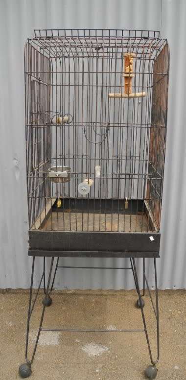 A well made metal bird cage on wheels