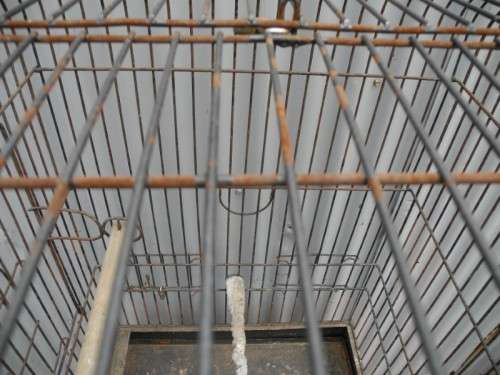 A well made metal bird cage on wheels