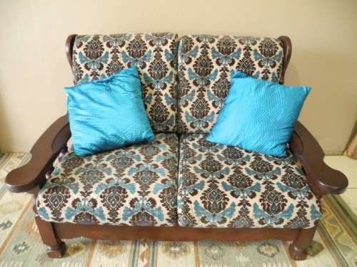 A colourful blue vintage Imbuia 2 seater couch - perfect in a lounge/patio/lapa.