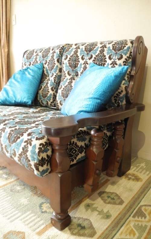 A colourful blue vintage Imbuia 2 seater couch - perfect in a lounge/patio/lapa.