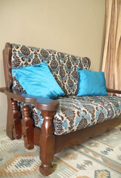 A colourful blue vintage Imbuia 2 seater couch - perfect in a lounge/patio/lapa.