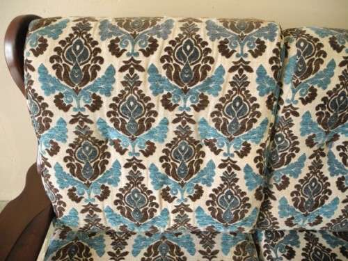 A colourful blue vintage Imbuia 2 seater couch - perfect in a lounge/patio/lapa.