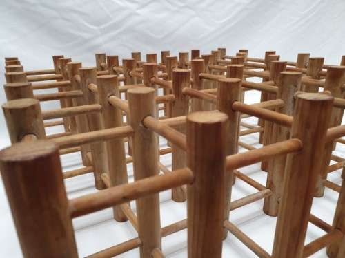 Stylish and practical table-top wooden wine rack with space for 36 wine bottles.