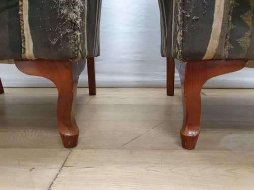 A pair of vintage Queen Anne footed Wingback upholstered arm chairs