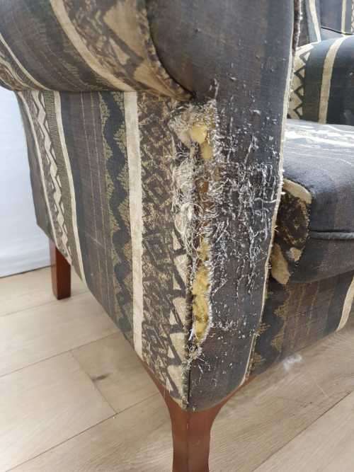 A pair of vintage Queen Anne footed Wingback upholstered arm chairs