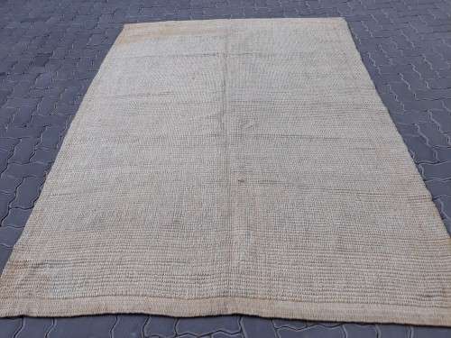A large beige coloured wool carpet