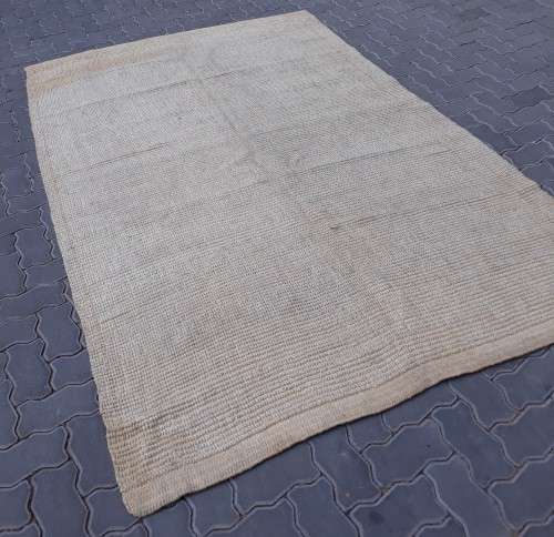 A large beige coloured wool carpet