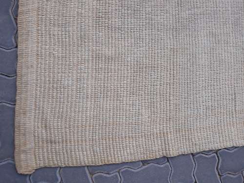 A large beige coloured wool carpet
