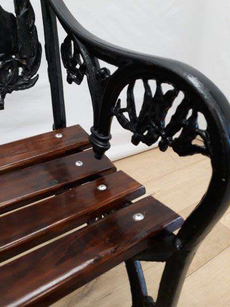 A cast iron slatted wood all weather garden/ patio bench.