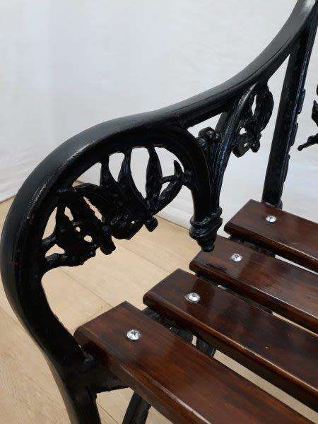 A cast iron slatted wood all weather garden/ patio bench.