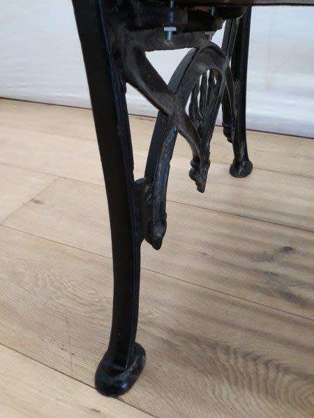 A cast iron slatted wood all weather garden/ patio bench.