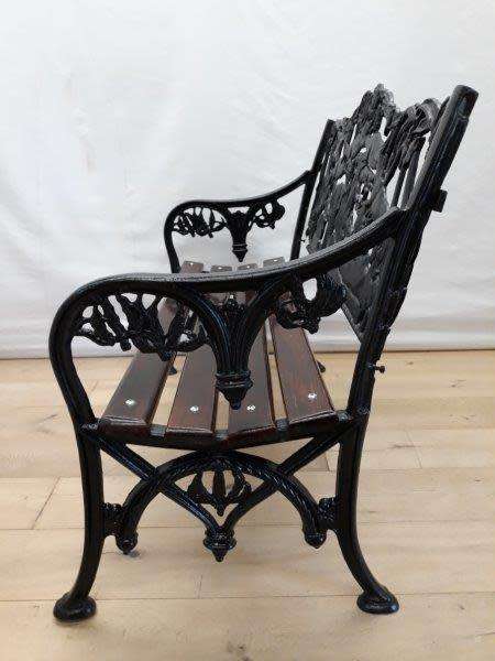 A cast iron slatted wood all weather garden/ patio bench.