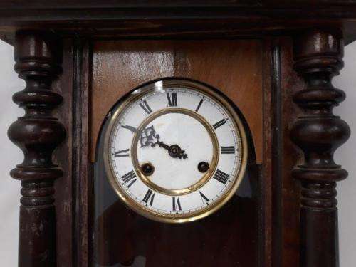 A gorgeous vintage wall hanging clock case with a glass door for restoration