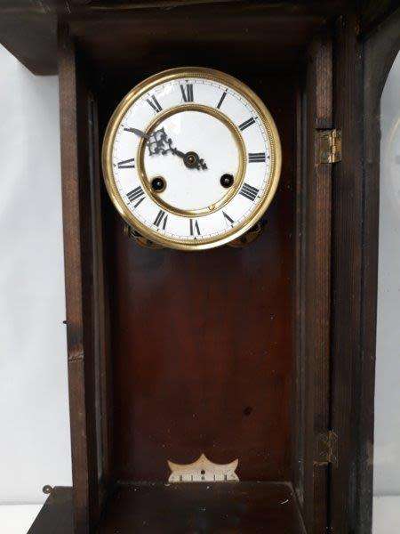 A gorgeous vintage wall hanging clock case with a glass door for restoration