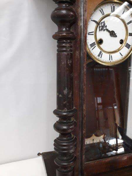 A gorgeous vintage wall hanging clock case with a glass door for restoration