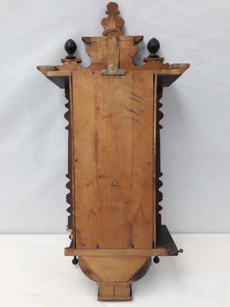 A gorgeous vintage wall hanging clock case with a glass door for restoration