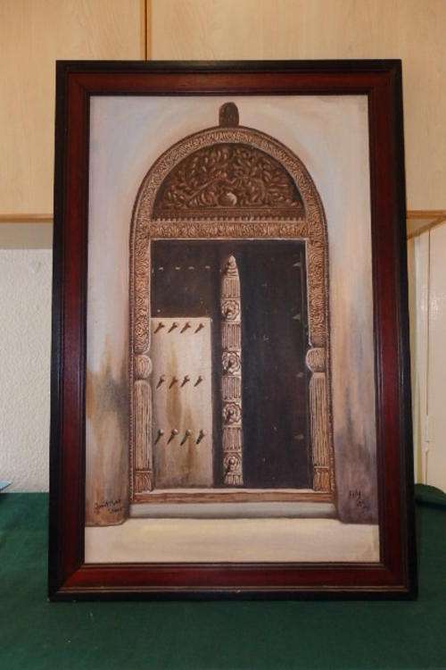 A STUNNING FRAMED OIL ON BOARD PAINTING OF ONE OF THE FAMOUS ZANZIBAR FRONT DOORS
