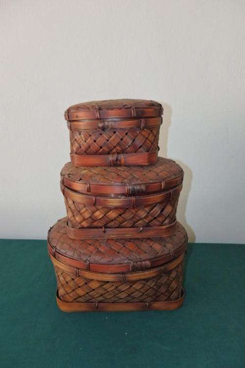 A STUNNING SET OF THREE OVAL "STACKABLE" WOVEN LIDDED BASKETS THAT ARE IDEAL FOR STORAGE