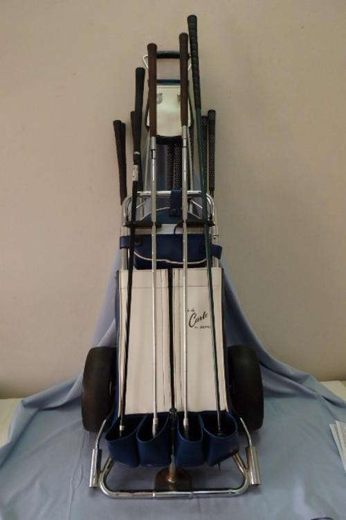 AN AWESOME VINTAGE "A' LA CARTE" GOLF CART WITH AN ASSORTMENT OF CLUBS, WOODS AND A PUTTER