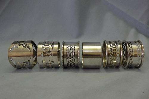 A GORGEOUS COLLECTION OF SIX ASSORTED VINTAGE SILVER PLATED SERVIETTE/ NAPKIN RINGS