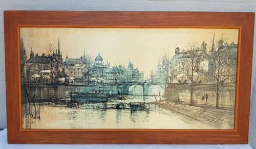 A large framed print of a town scene