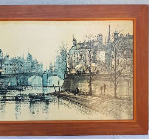 A large framed print of a town scene