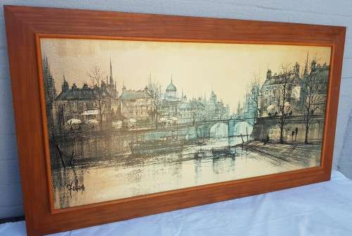 A large framed print of a town scene