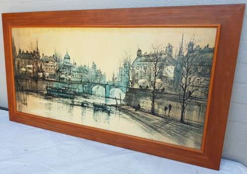 A large framed print of a town scene