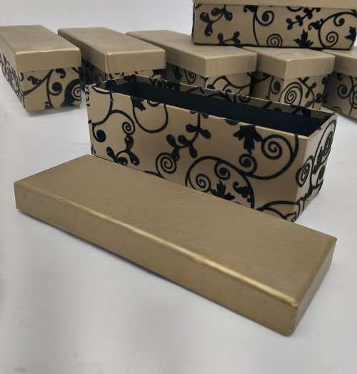A lovely collection of 7x gold lidded boxes with black velvet brocade pattern detailing