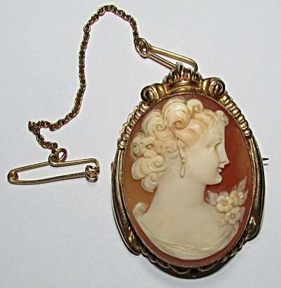 A Cameo Brooch/Pendant with Ornate 9CT Frame and Safety Pin ( Valued at R 8700.00 )